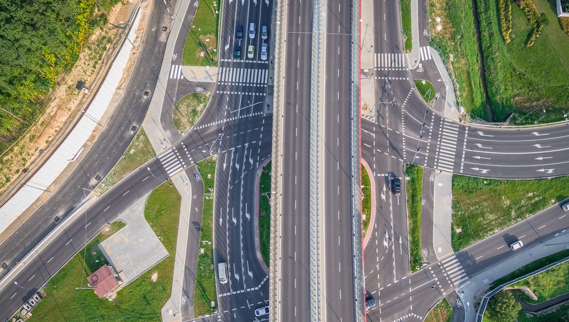 An aerial shot of a highway overpass above several roads.