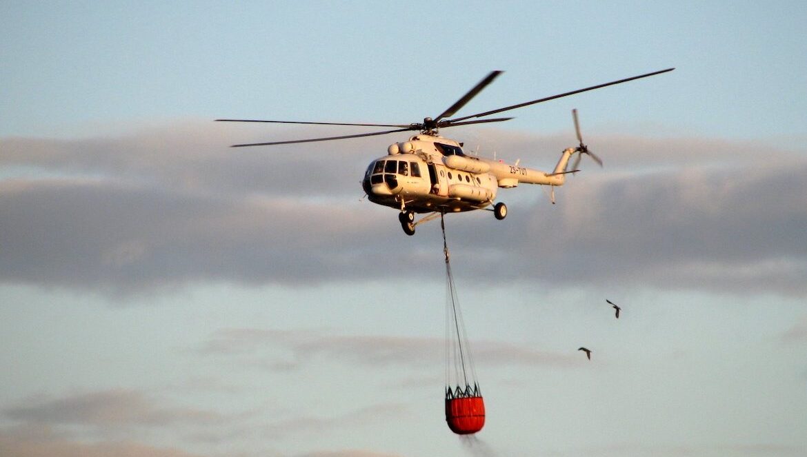 Helicopter carrying water to a fire